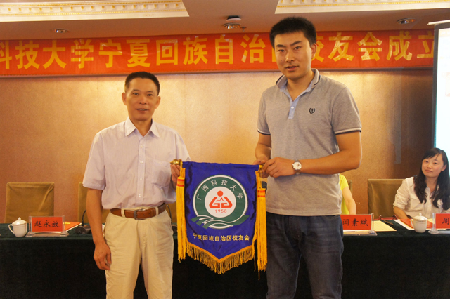 3.黎平为新当选的会长赵永放校友授“广西科技大学宁夏回族自治区校友会”会旗.jpg